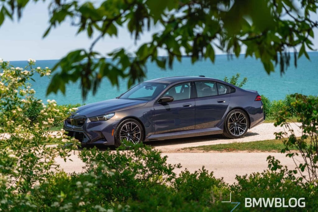 2025 BMW M5 G90 in Sepia Metallic parked by the lake