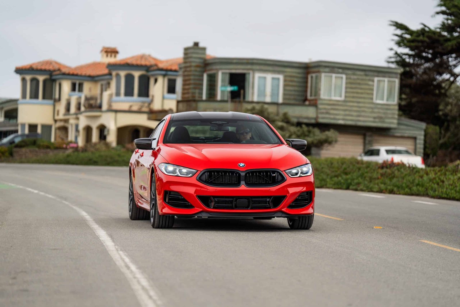 2026 BMW M850I HERITATE EDITION BRIGHT RED driving in Pebble Beach