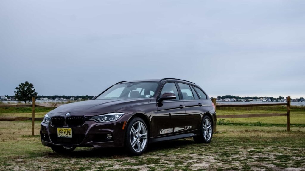 2019 BMW 330i Sports Wagon F31 three-quarter front view in Smoked Topaz metallic with M Sport package, black kidney grilles, and M Performance decals