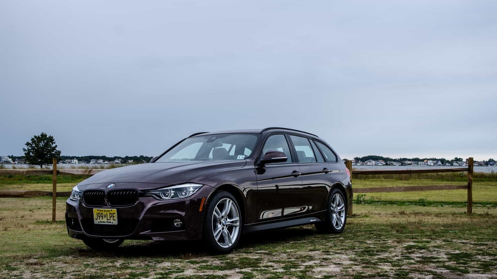 2019 BMW 330i Sports Wagon F31 three-quarter front view in Smoked Topaz metallic with M Sport package, black kidney grilles, and M Performance decals